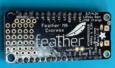 Soldering the headers onto the Feather